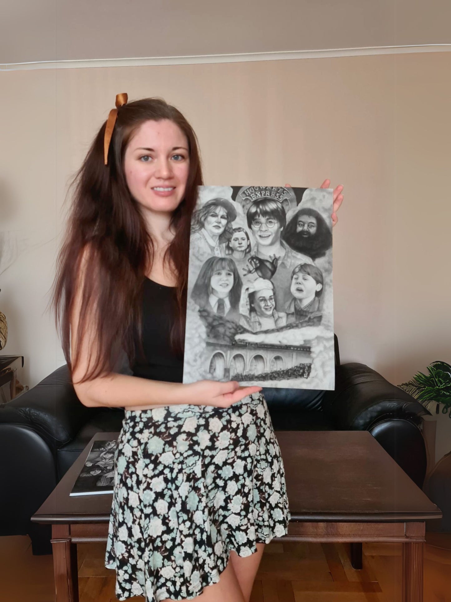 Karina holding Harry Potter art print featuring Harry, Ron, and Hermione's first meeting on the Hogwarts Express