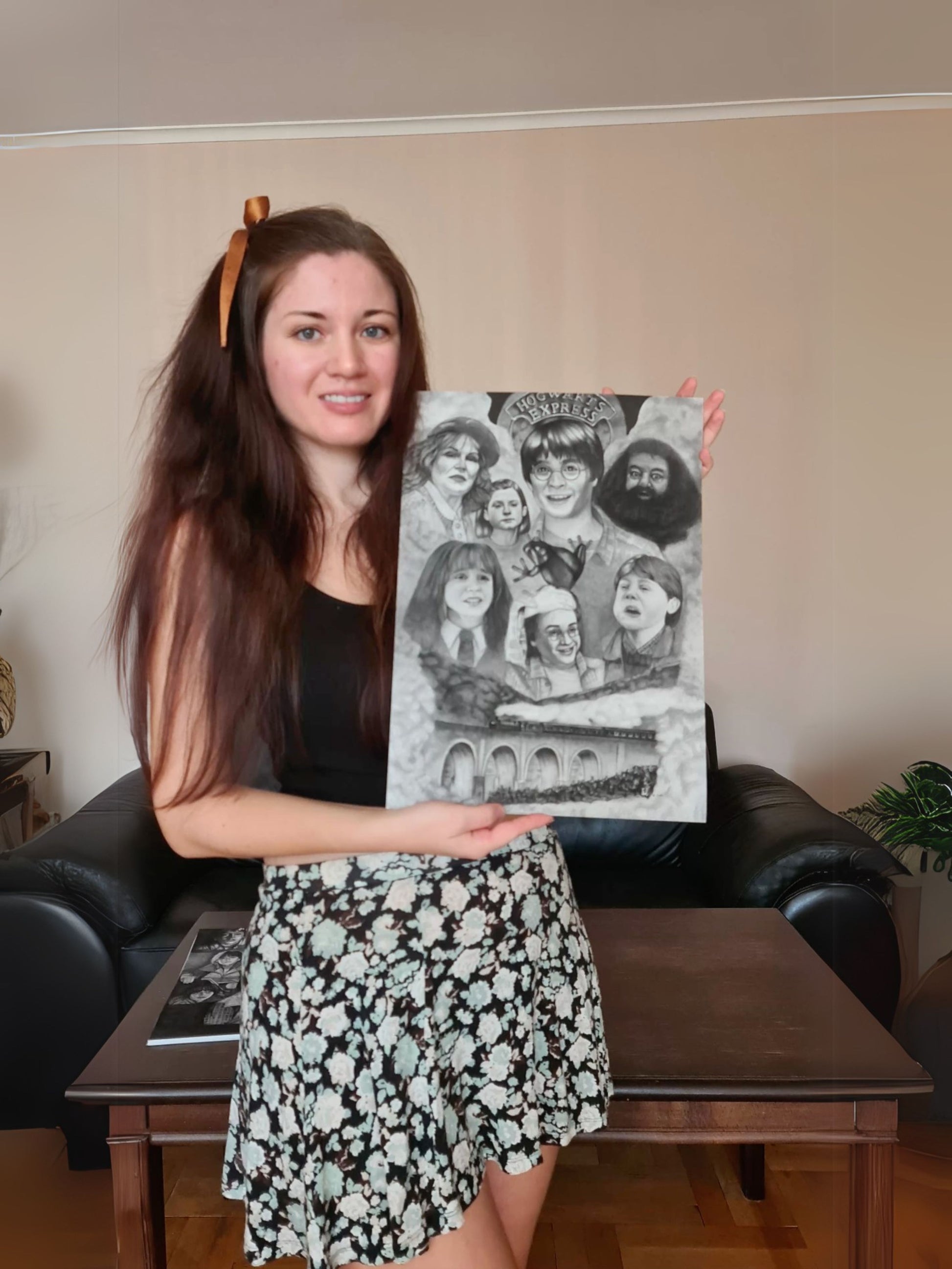 Karina holding Harry Potter art print featuring Harry, Ron, and Hermione's first meeting on the Hogwarts Express
